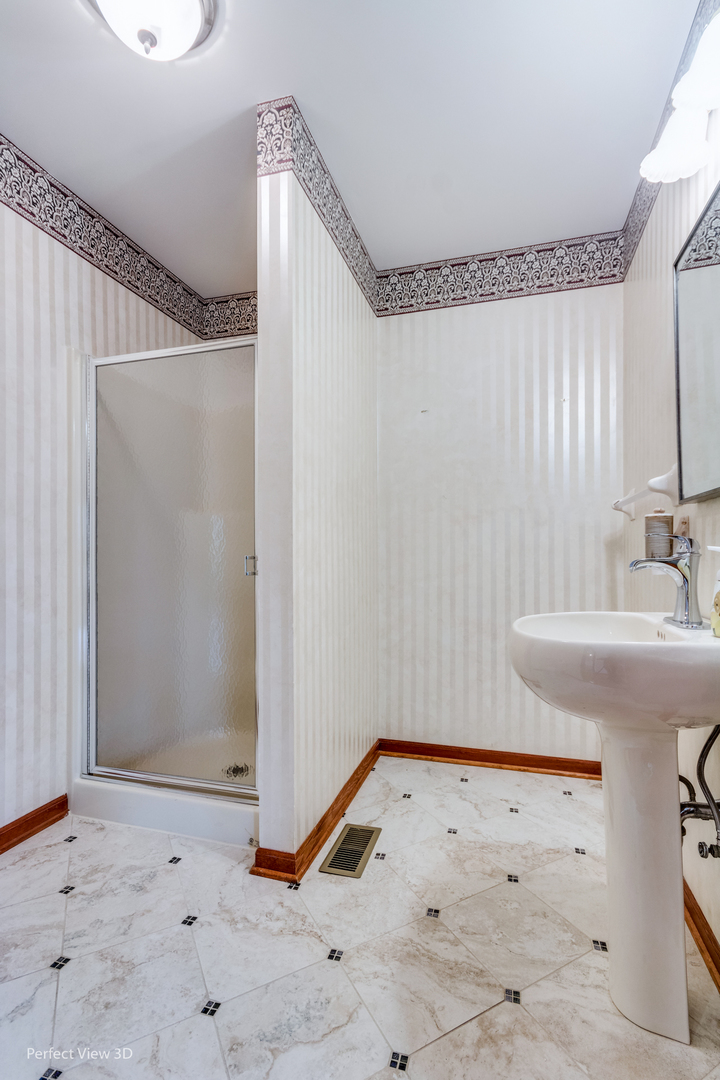 1 Genesee Court Bolingbrook, IL 60440 - Photo 17 of 29 a bathroom with a sink and a mirror