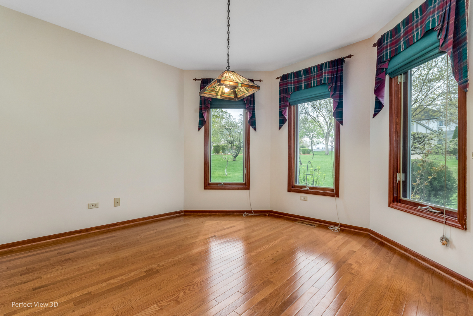 1 Genesee Court Bolingbrook, IL 60440 - Photo 7 of 29 a view of an empty room with wooden floor and windows