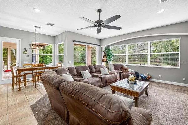 a spacious bedroom with a bed and a flat screen television