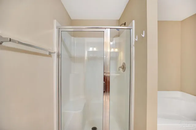 a bathroom with a glass shower door