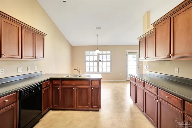 a kitchen with stainless steel appliances granite countertop a sink stove and cabinets
