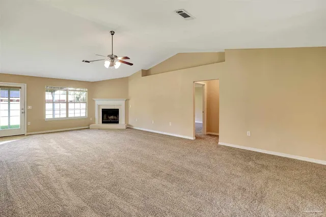 a view of empty room with windows and fireplace