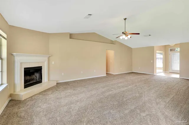 a view of empty room with a fireplace