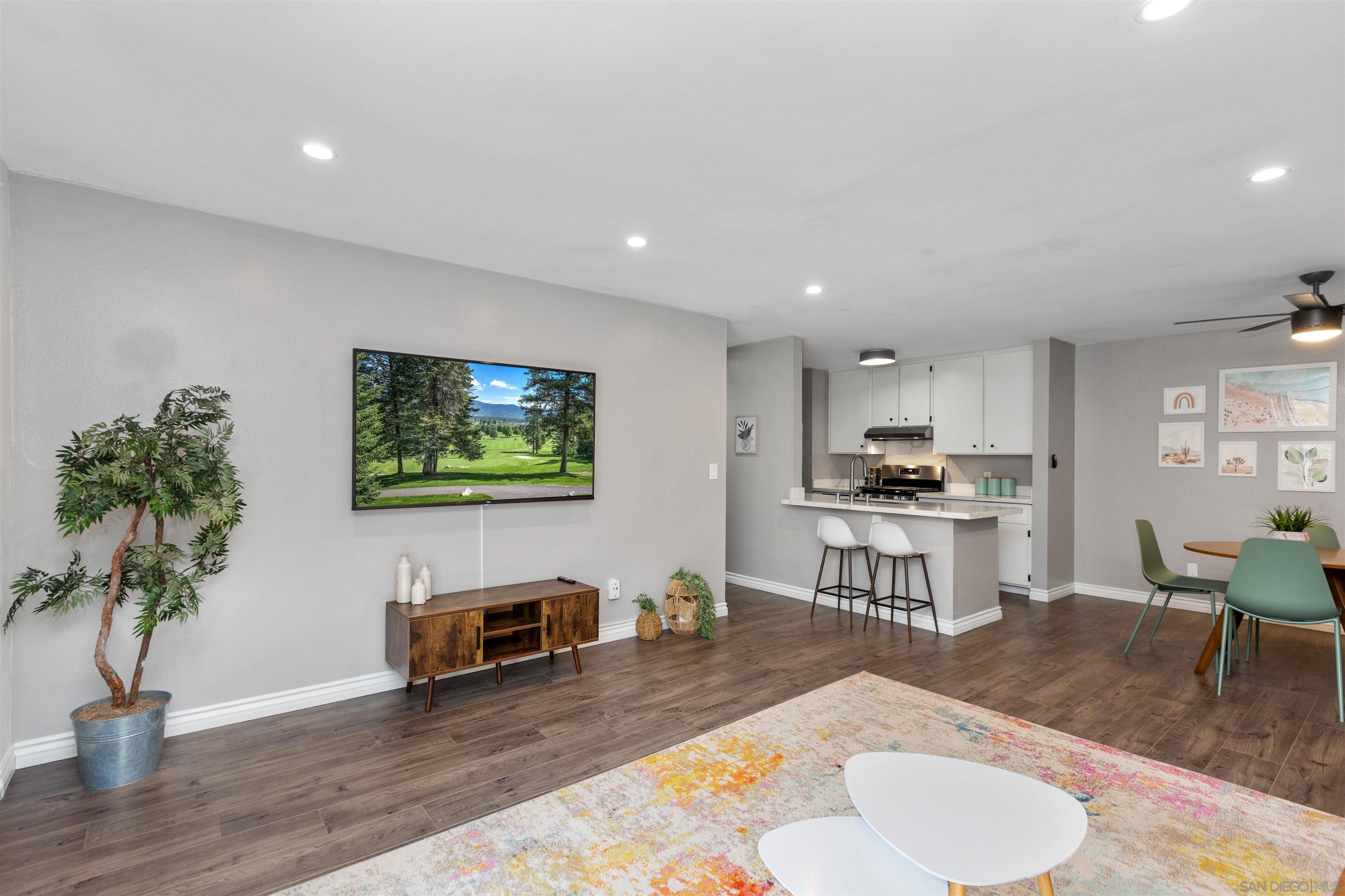 1621 Unit E 217, Unit E217 San Diego, CA 92108 - Photo 11 of 45 a living room with furniture and a flat screen tv