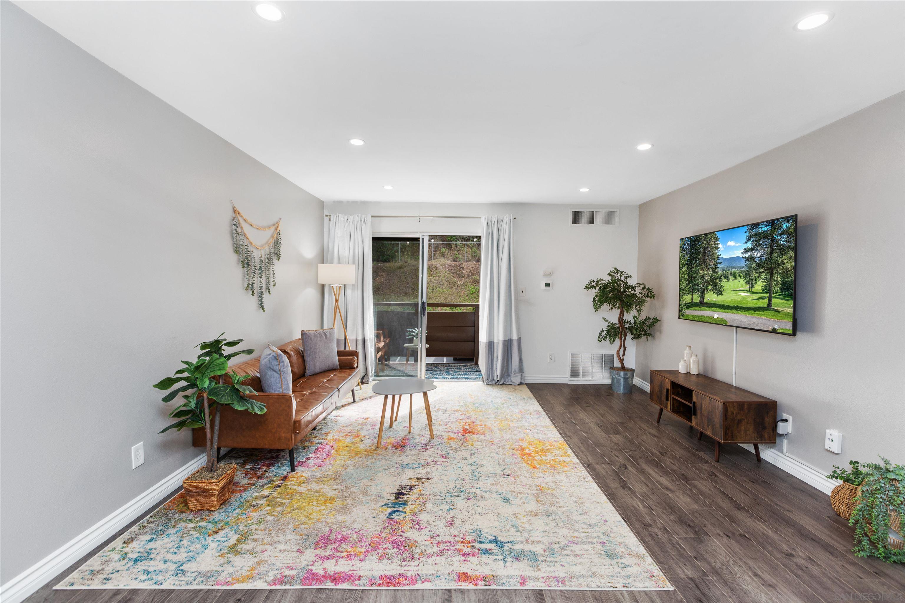 1621 Unit E 217, Unit E217 San Diego, CA 92108 - Photo 12 of 45 a living room with furniture and a potted plant