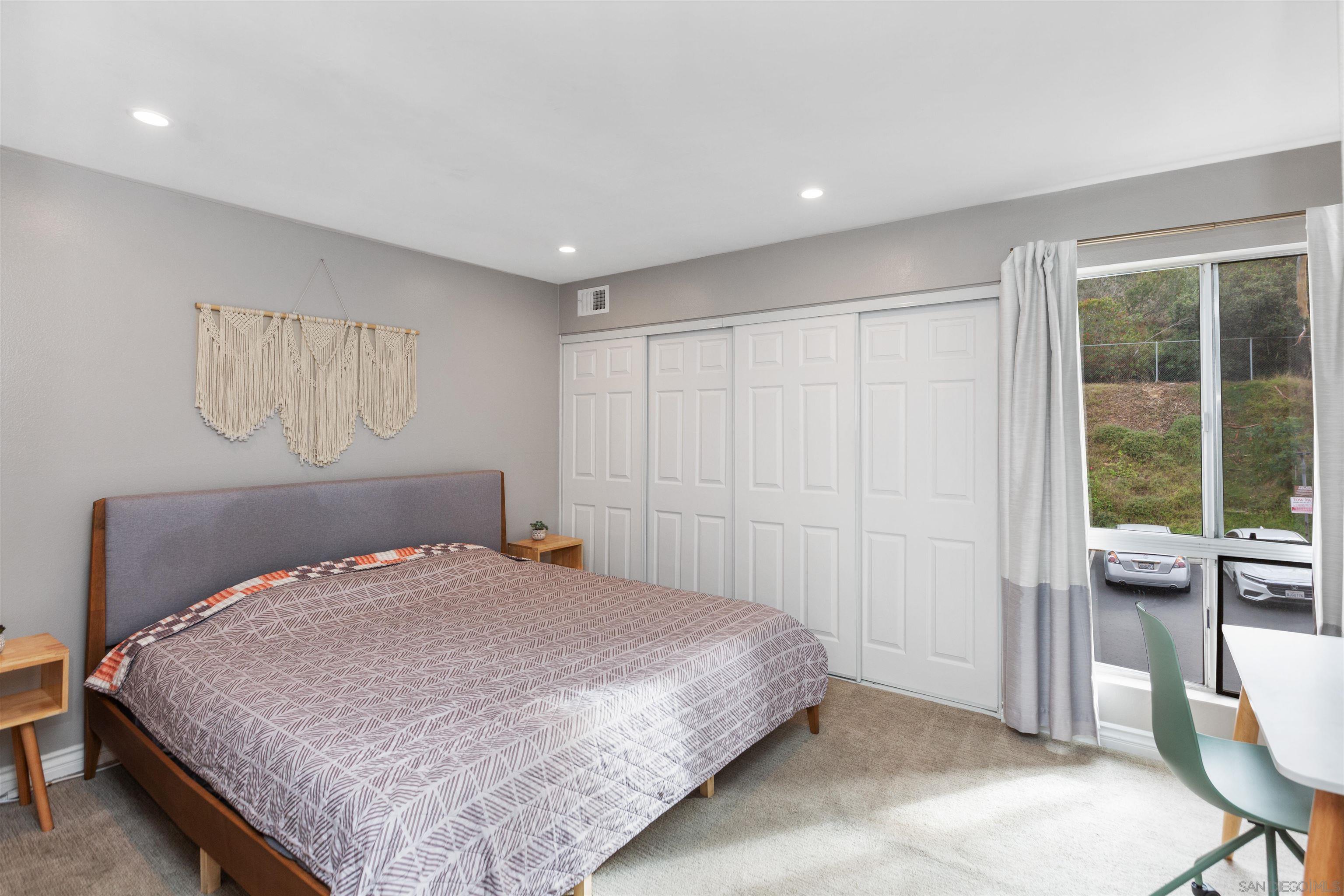 1621 Unit E 217, Unit E217 San Diego, CA 92108 - Photo 15 of 45 a bedroom with a large bed and a window