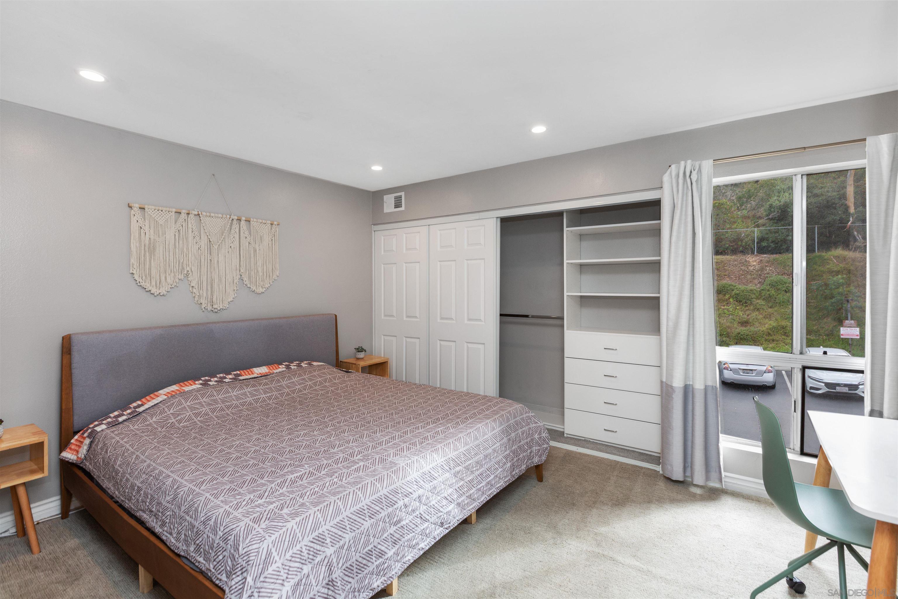 1621 Unit E 217, Unit E217 San Diego, CA 92108 - Photo 16 of 45 a bedroom with a bed and a desk