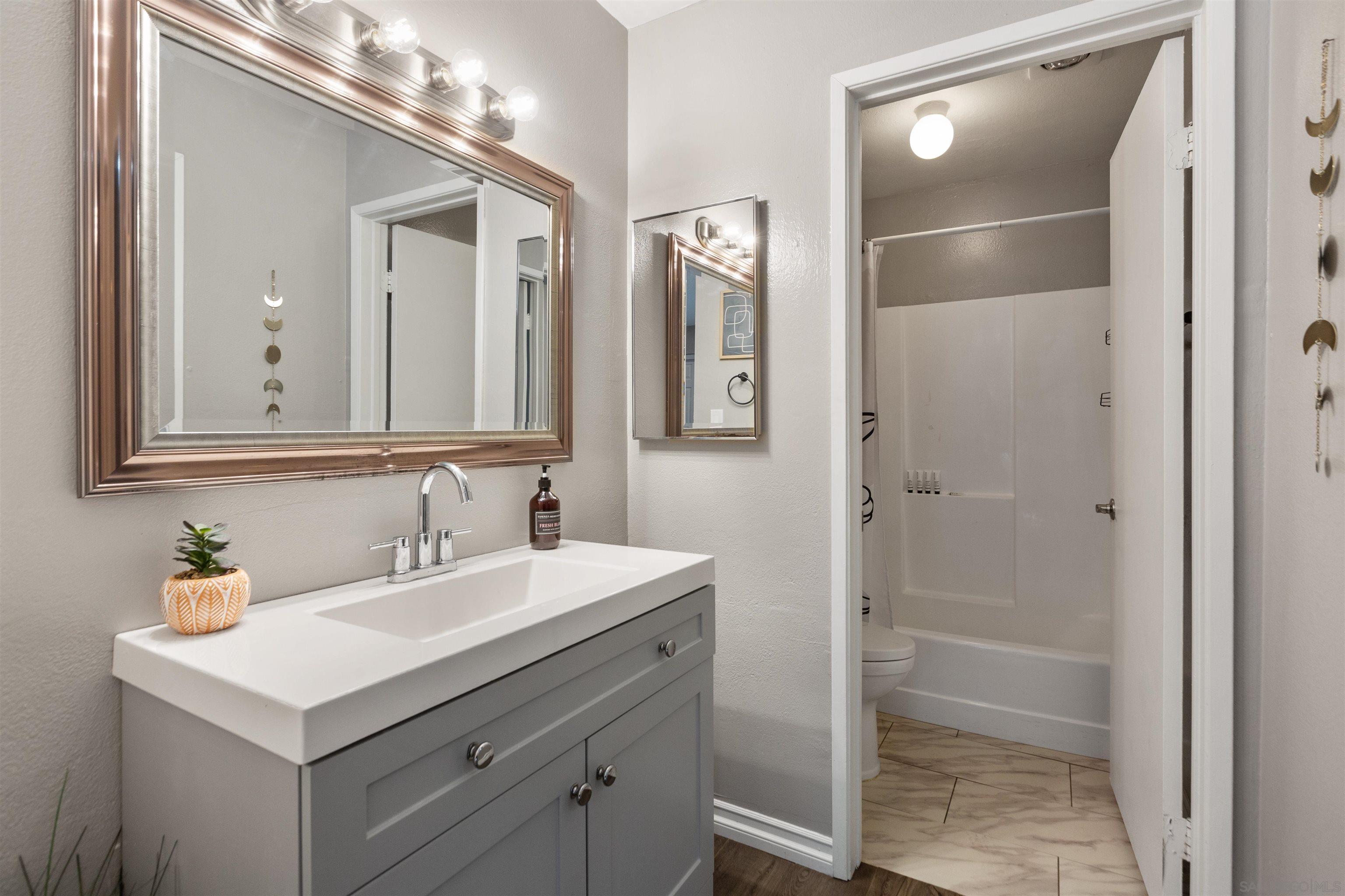 1621 Unit E 217, Unit E217 San Diego, CA 92108 - Photo 19 of 45 a bathroom with a sink and a mirror