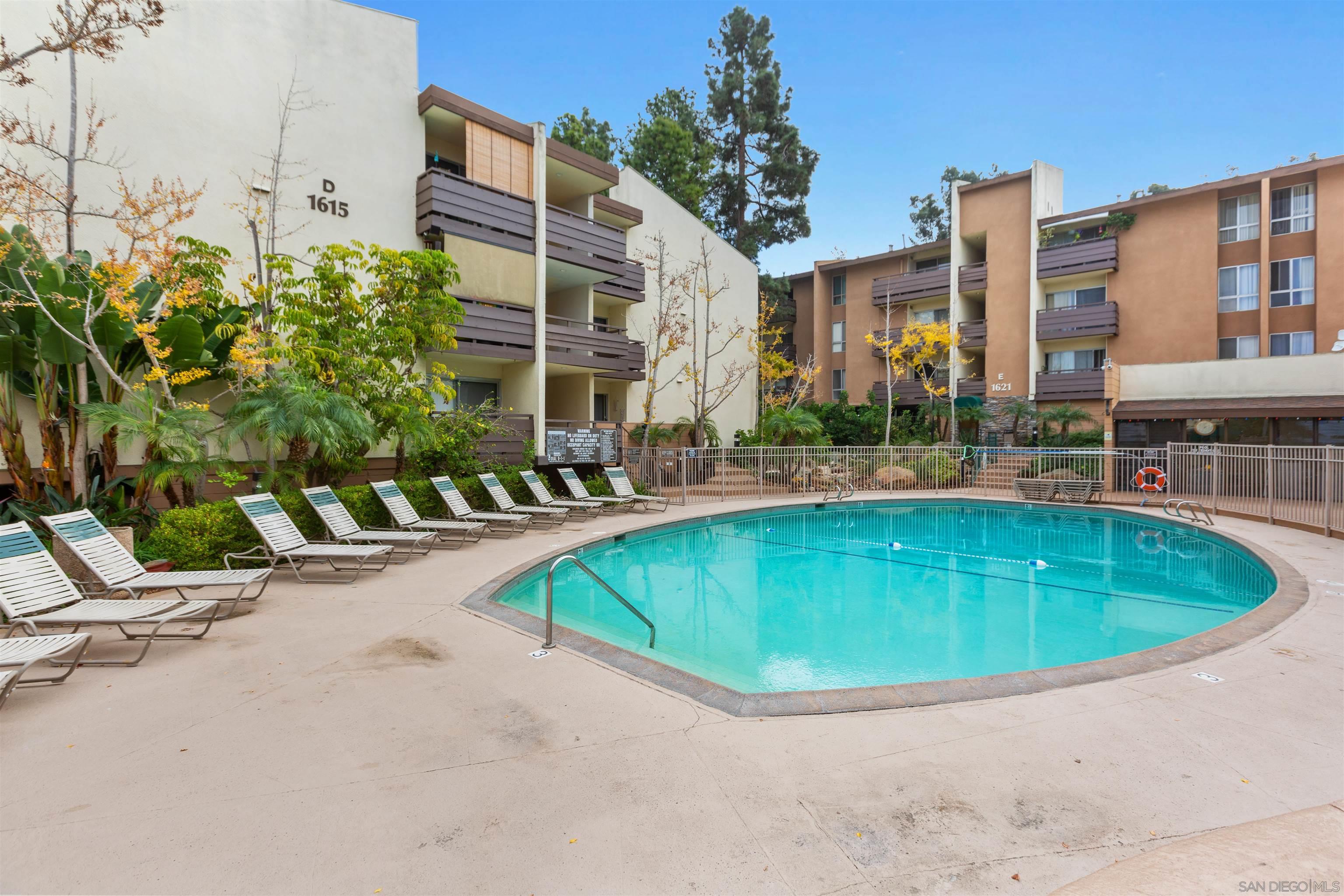 1621 Unit E 217, Unit E217 San Diego, CA 92108 - Photo 31 of 45 a swimming pool with outdoor seating and yard
