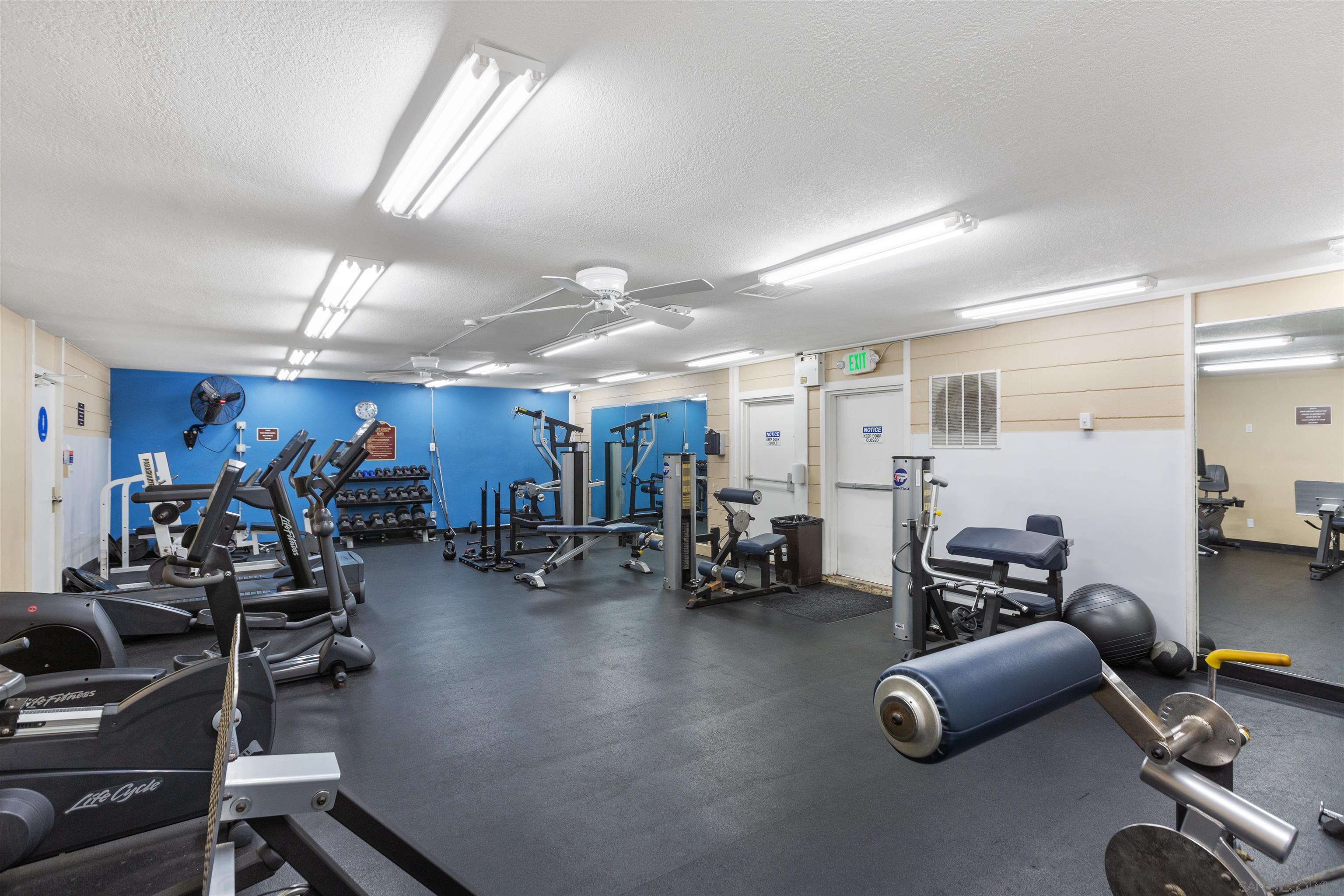 1621 Unit E 217, Unit E217 San Diego, CA 92108 - Photo 40 of 45 a room with gym equipment and a large window