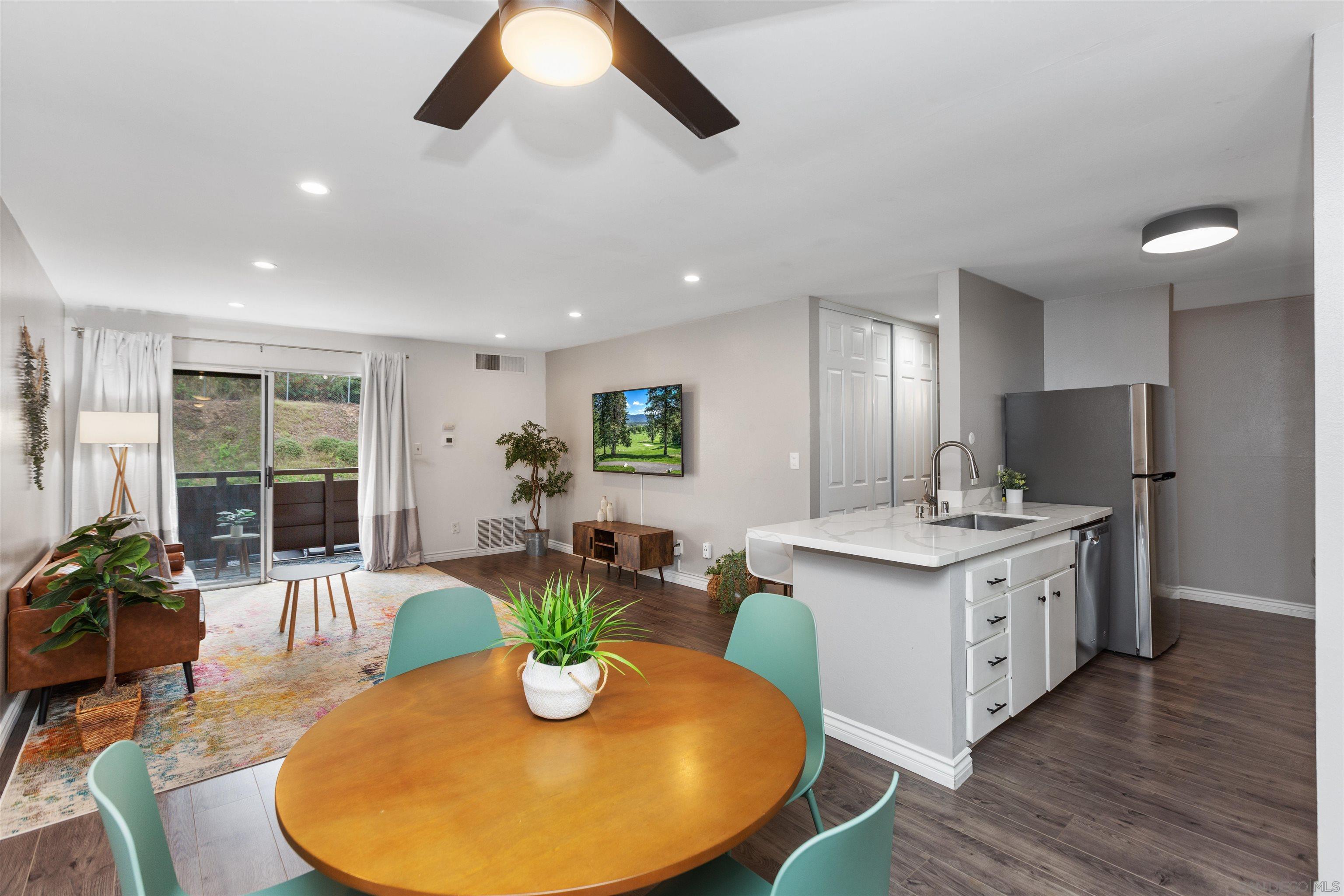 1621 Unit E 217, Unit E217 San Diego, CA 92108 - Photo 4 of 45 a view of a dining room with furniture window and wooden floor