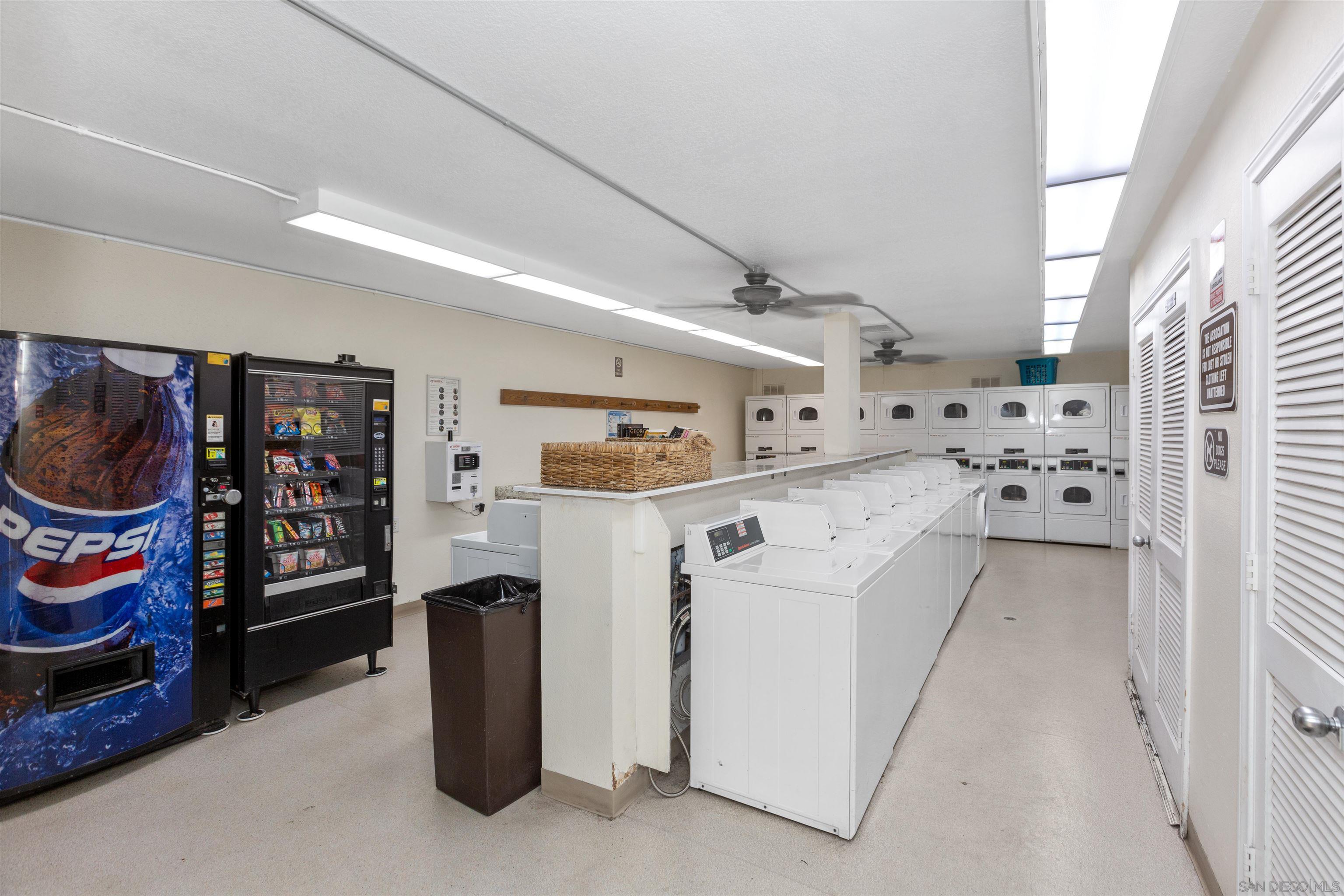1621 Unit E 217, Unit E217 San Diego, CA 92108 - Photo 43 of 45 a utility room with lot of cabinets and washer dryer