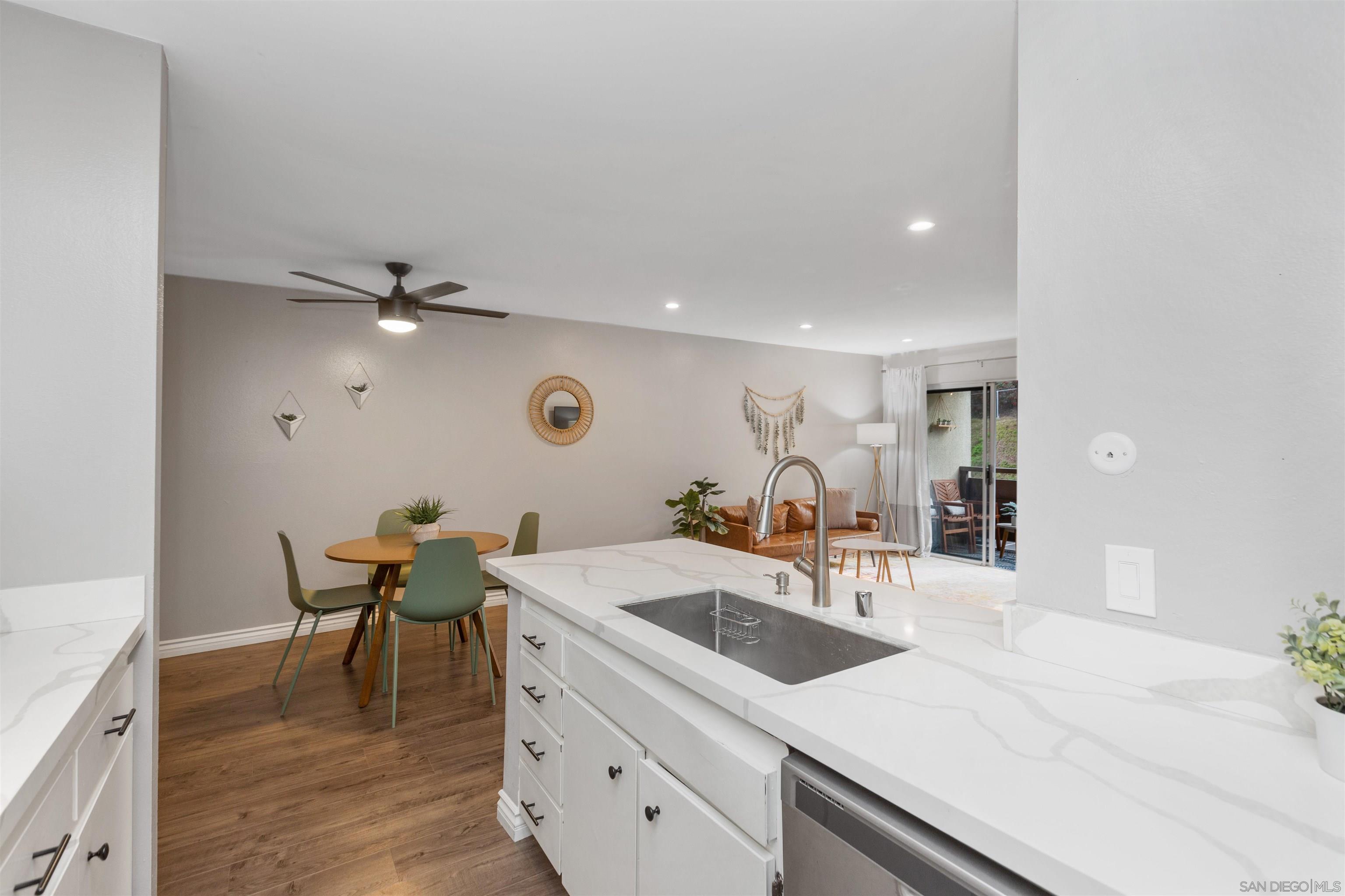 1621 Unit E 217, Unit E217 San Diego, CA 92108 - Photo 5 of 45 a kitchen with a sink cabinets and wooden floor