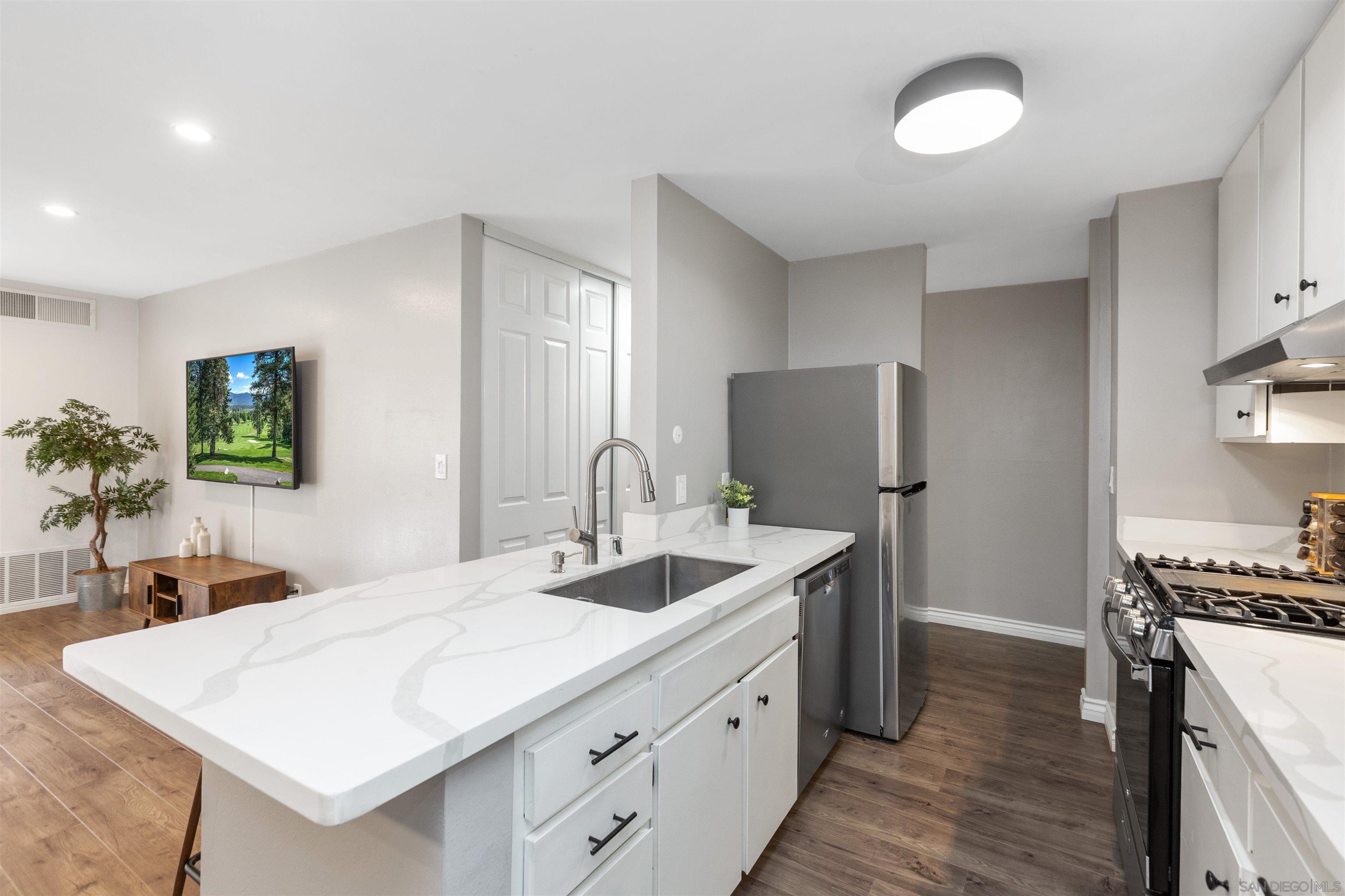 1621 Unit E 217, Unit E217 San Diego, CA 92108 - Photo 6 of 45 a bathroom with a sink and a mirror