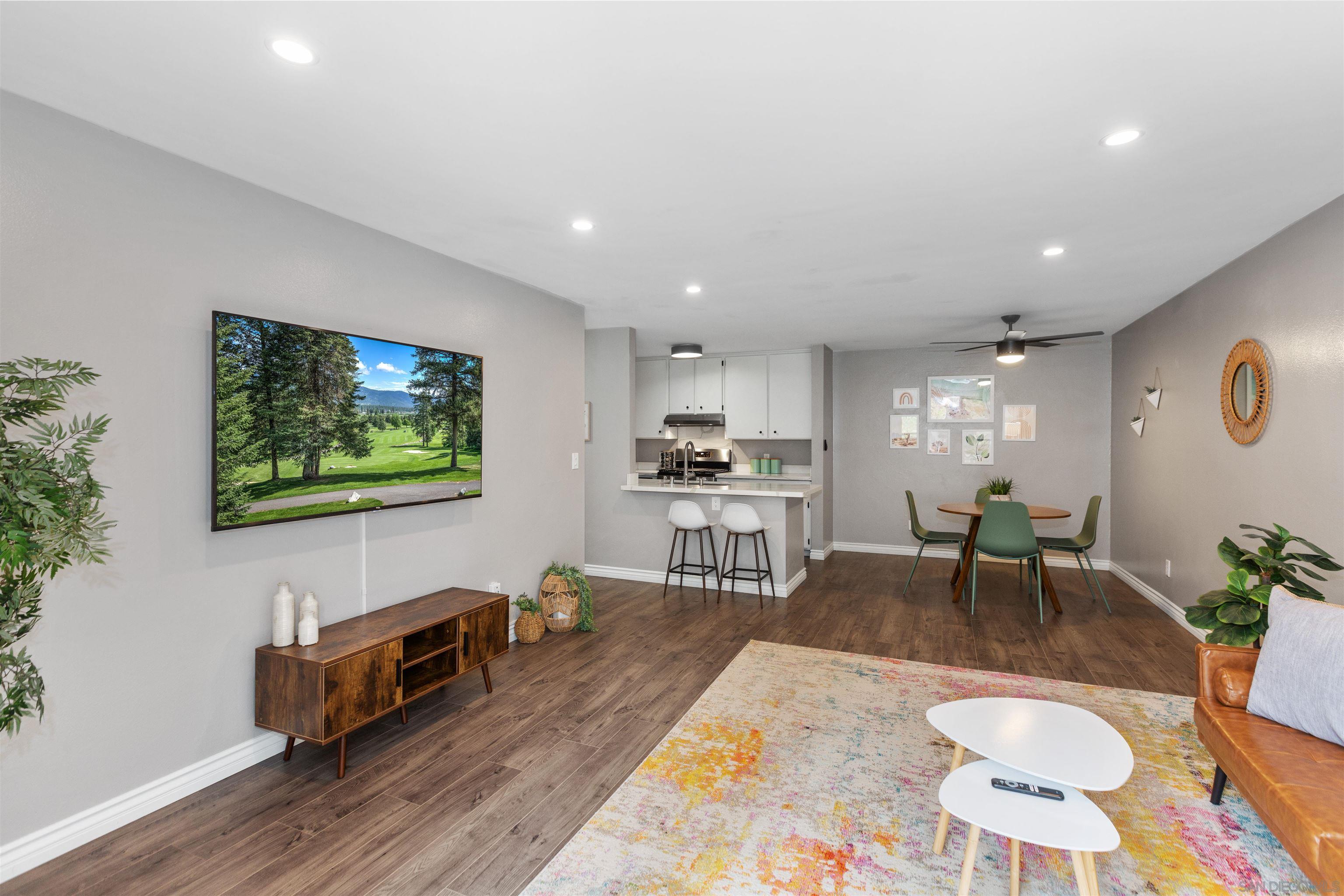1621 Unit E 217, Unit E217 San Diego, CA 92108 - Photo 10 of 45 a living room with furniture and a flat screen tv