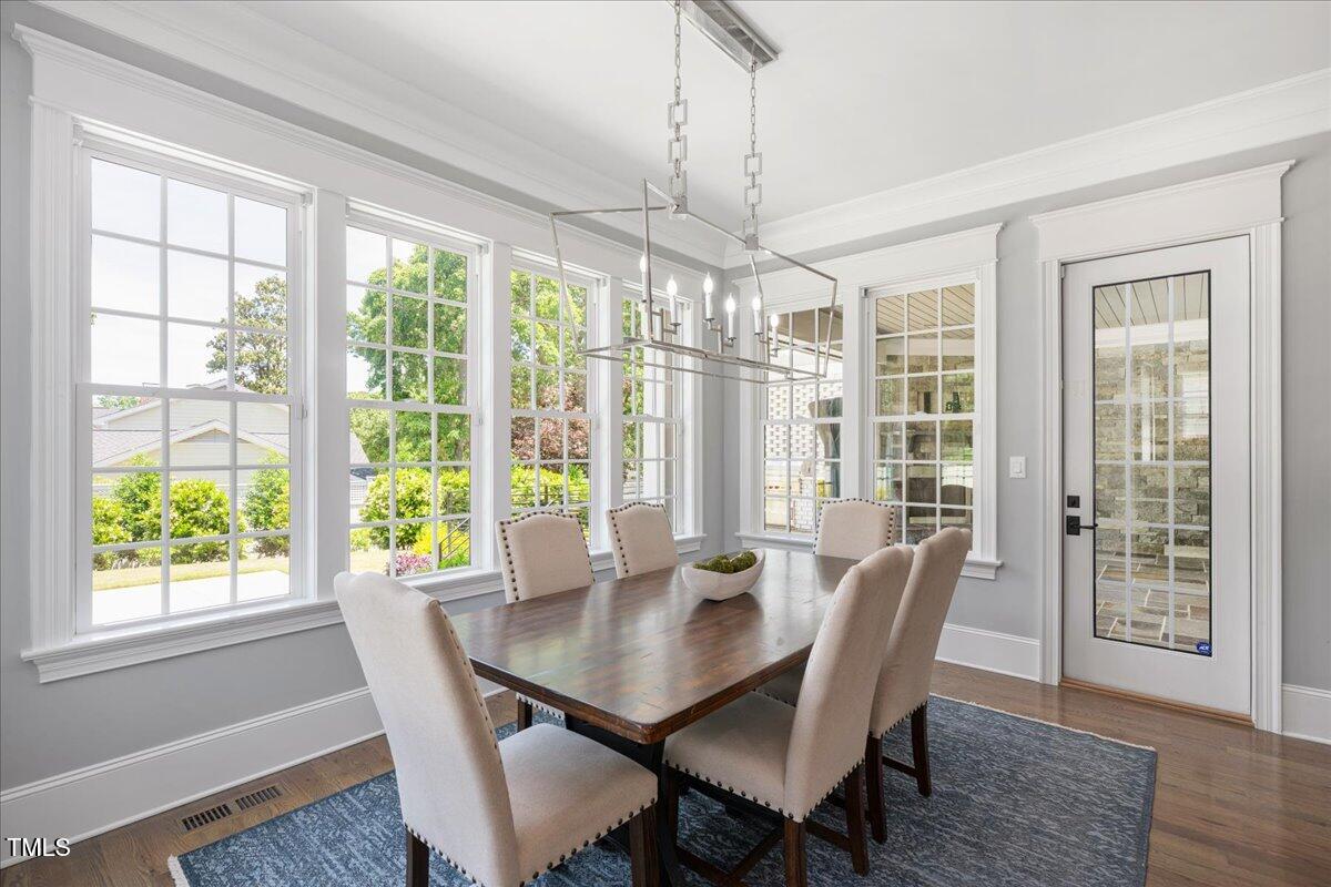 6502 New Market Way Raleigh, NC 27615 - Photo 16 of 54 a view of a dining room with furniture window and wooden floor