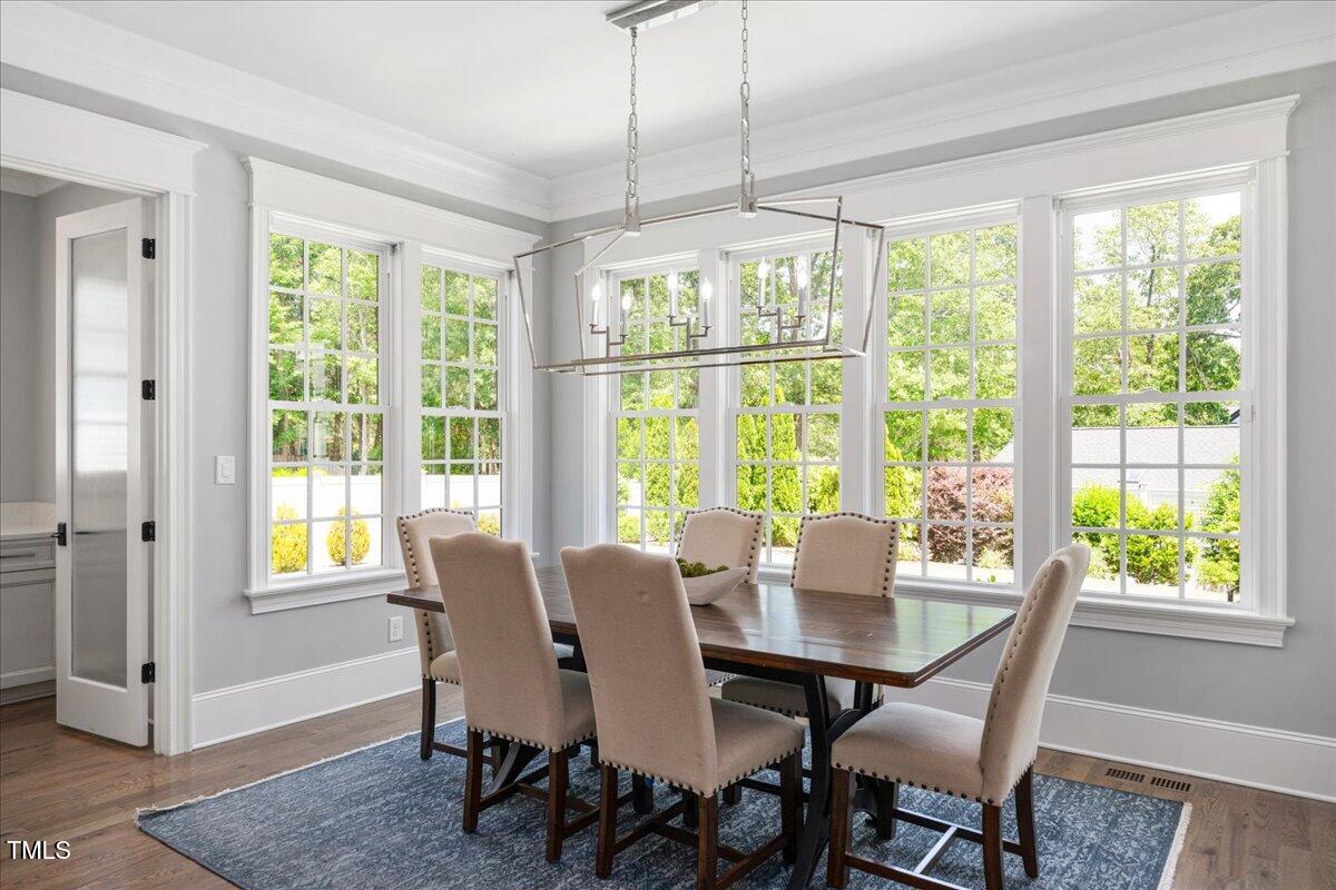 6502 New Market Way Raleigh, NC 27615 - Photo 17 of 54 a view of a dining room with furniture window and outside view