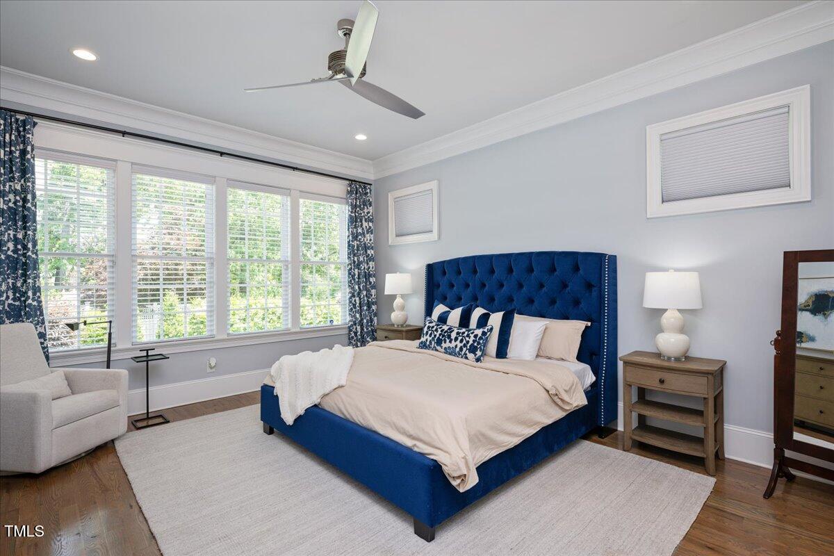 6502 New Market Way Raleigh, NC 27615 - Photo 22 of 54 a spacious bedroom with a bed and a couch