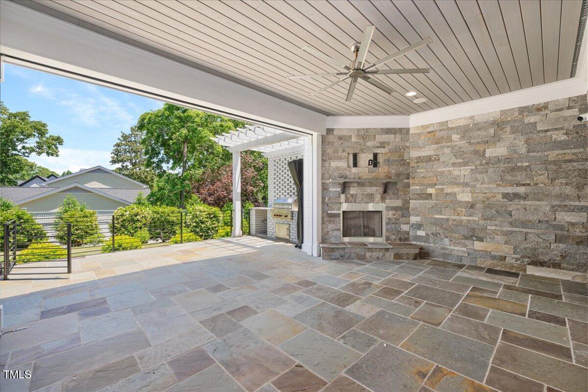 6502 New Market Way Raleigh, NC 27615 - Photo 26 of 54 a view of a porch with a table and chairs under an umbrella
