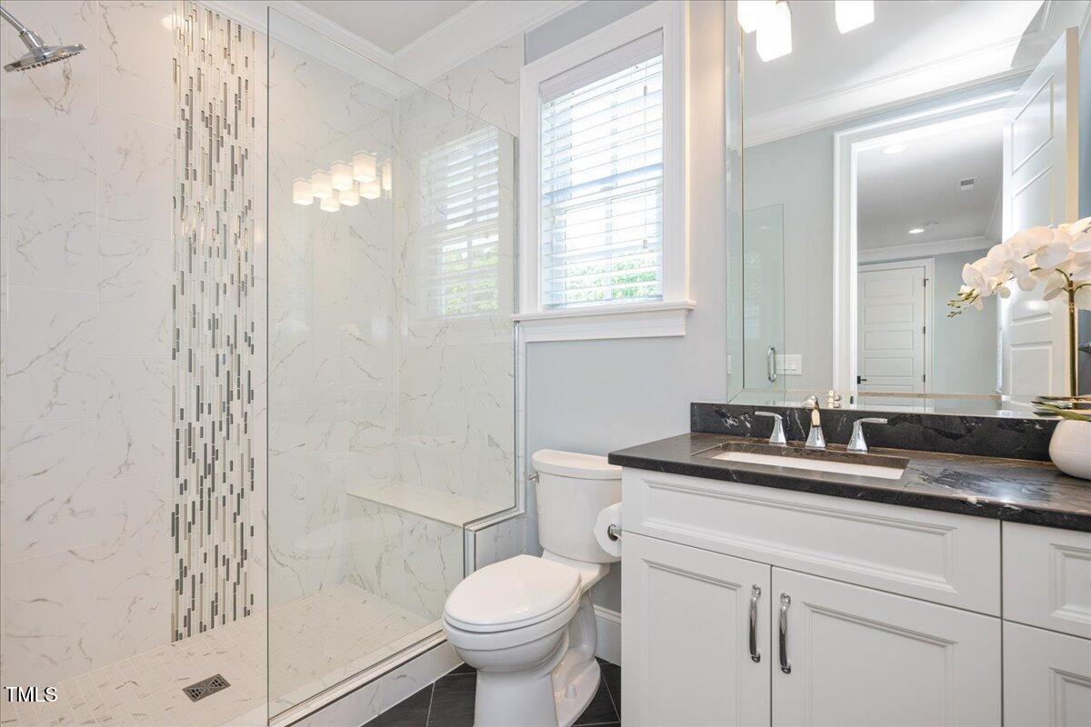 6502 New Market Way Raleigh, NC 27615 - Photo 29 of 54 a bathroom with a granite countertop sink toilet and shower