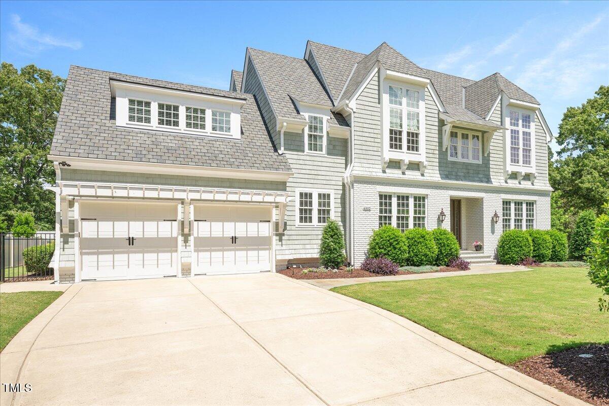 6502 New Market Way Raleigh, NC 27615 - Photo 3 of 54 a front view of a building with a garden
