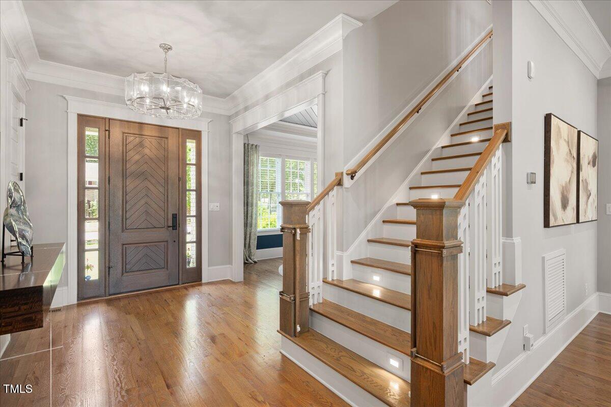 6502 New Market Way Raleigh, NC 27615 - Photo 4 of 54 a view of an entryway with wooden floor and door