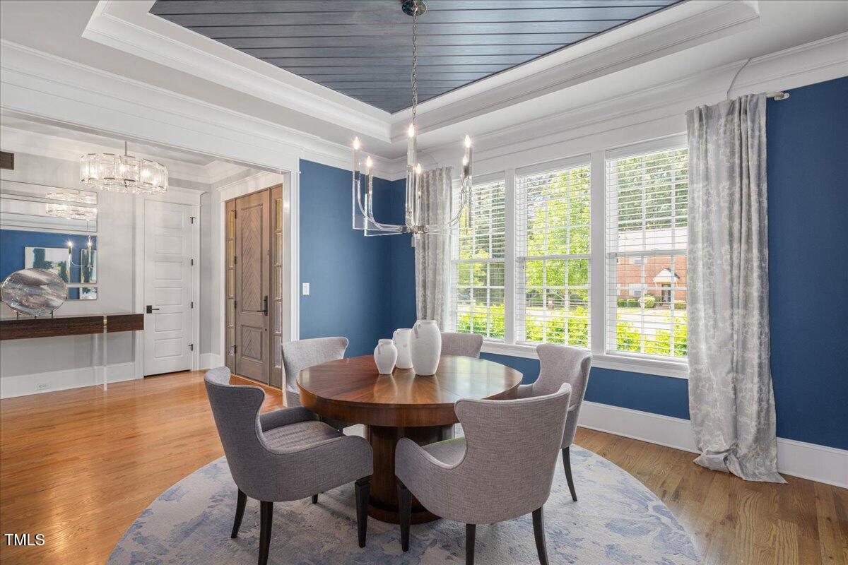 6502 New Market Way Raleigh, NC 27615 - Photo 6 of 54 a dining room with furniture window and wooden floor