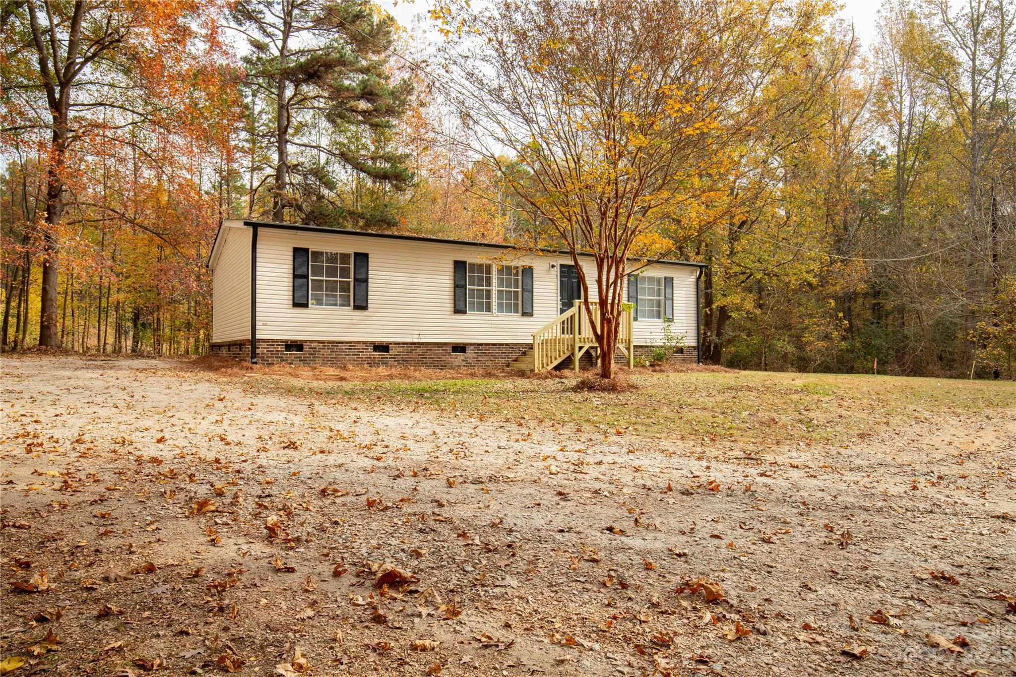 995 Longleaf Road York, SC 29745 - Photo 1 of 30 a backyard of house with large trees