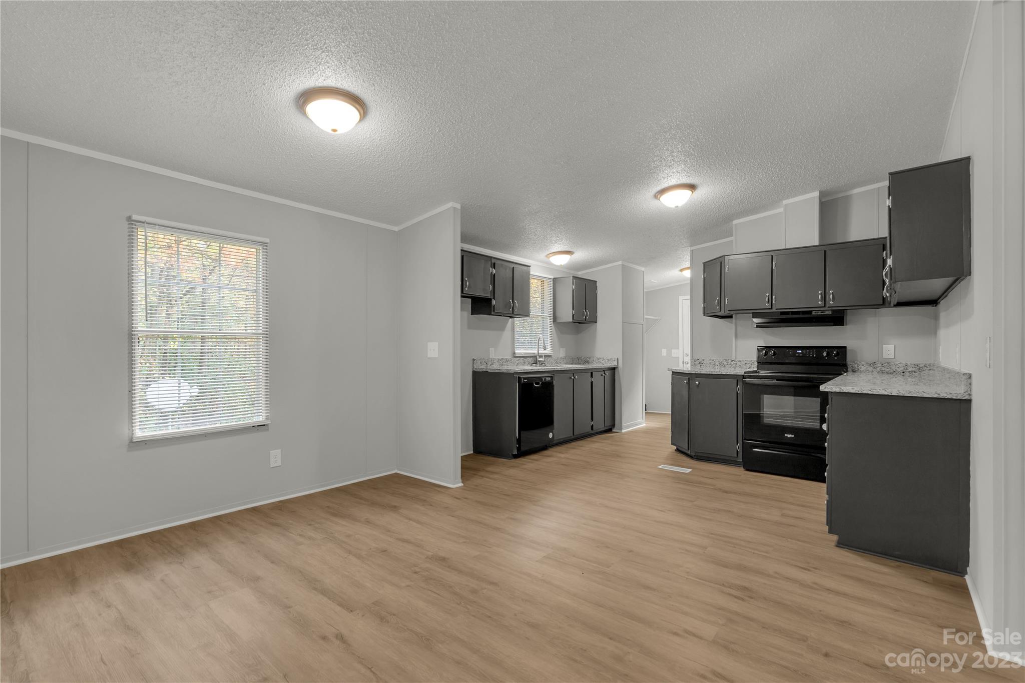 995 Longleaf Road York, SC 29745 - Photo 11 of 30 a kitchen with stainless steel appliances granite countertop a refrigerator oven a sink dishwasher and a stove with wooden floor