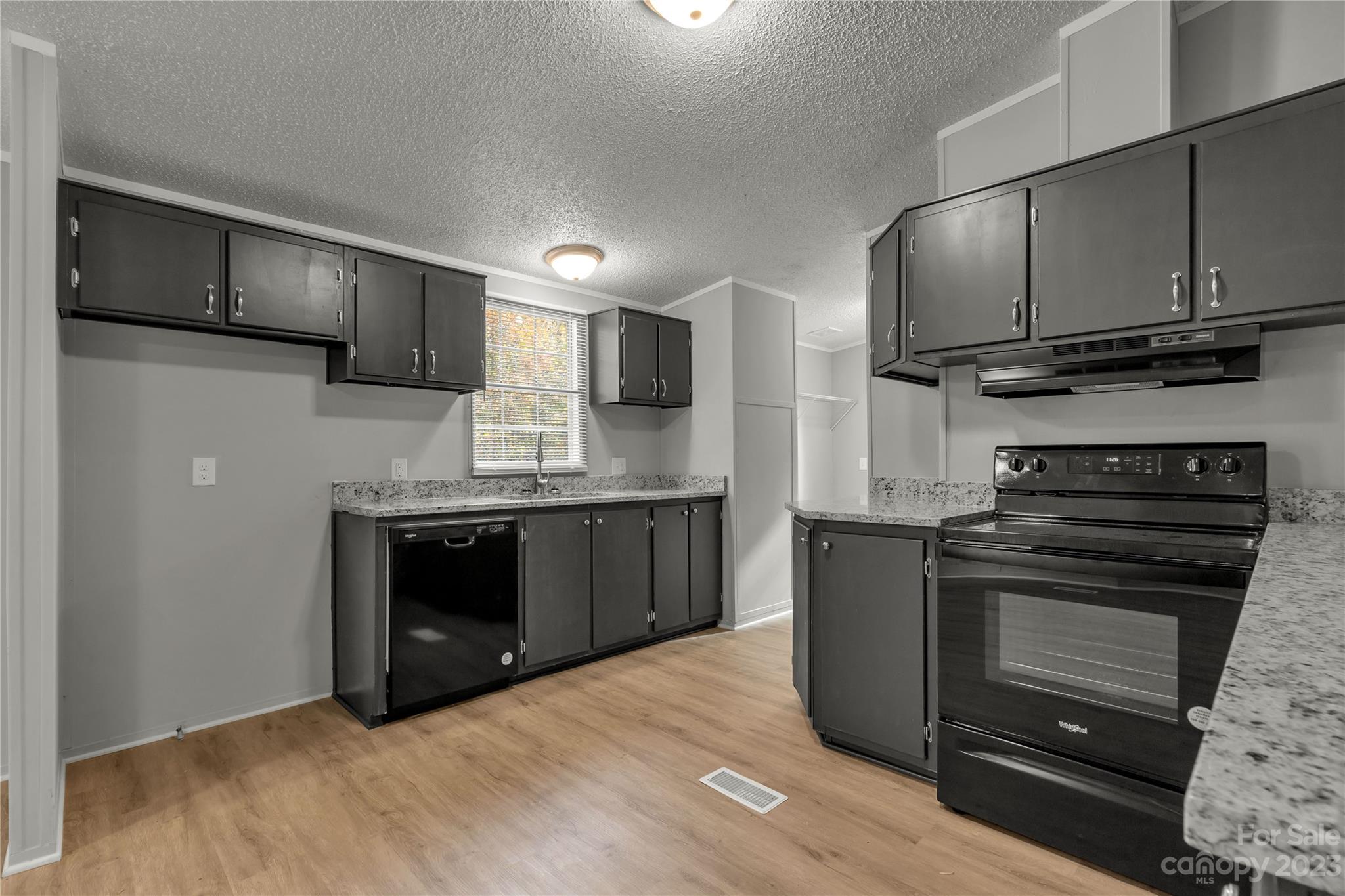 995 Longleaf Road York, SC 29745 - Photo 13 of 30 a kitchen with stainless steel appliances granite countertop a refrigerator and a stove top oven