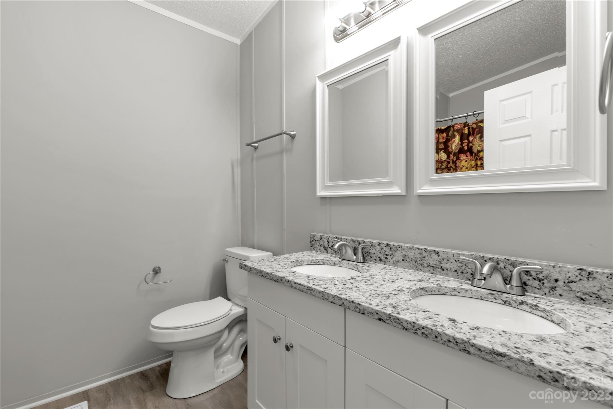 995 Longleaf Road York, SC 29745 - Photo 18 of 30 a bathroom with a granite countertop toilet sink and mirror