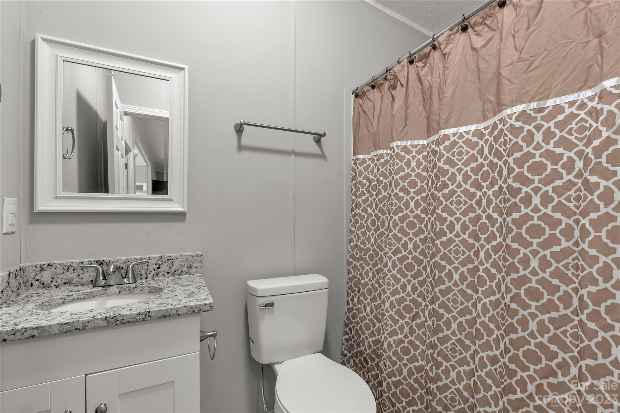 995 Longleaf Road York, SC 29745 - Photo 21 of 30 a bathroom with a granite countertop toilet and a sink