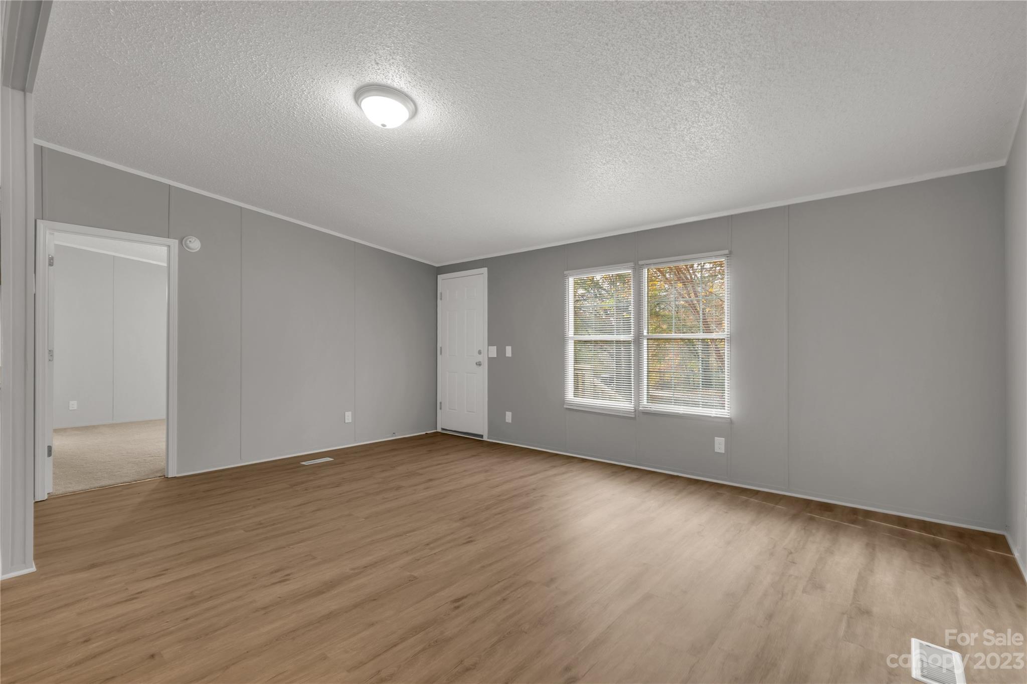 995 Longleaf Road York, SC 29745 - Photo 9 of 30 a view of an empty room with wooden floor and a window