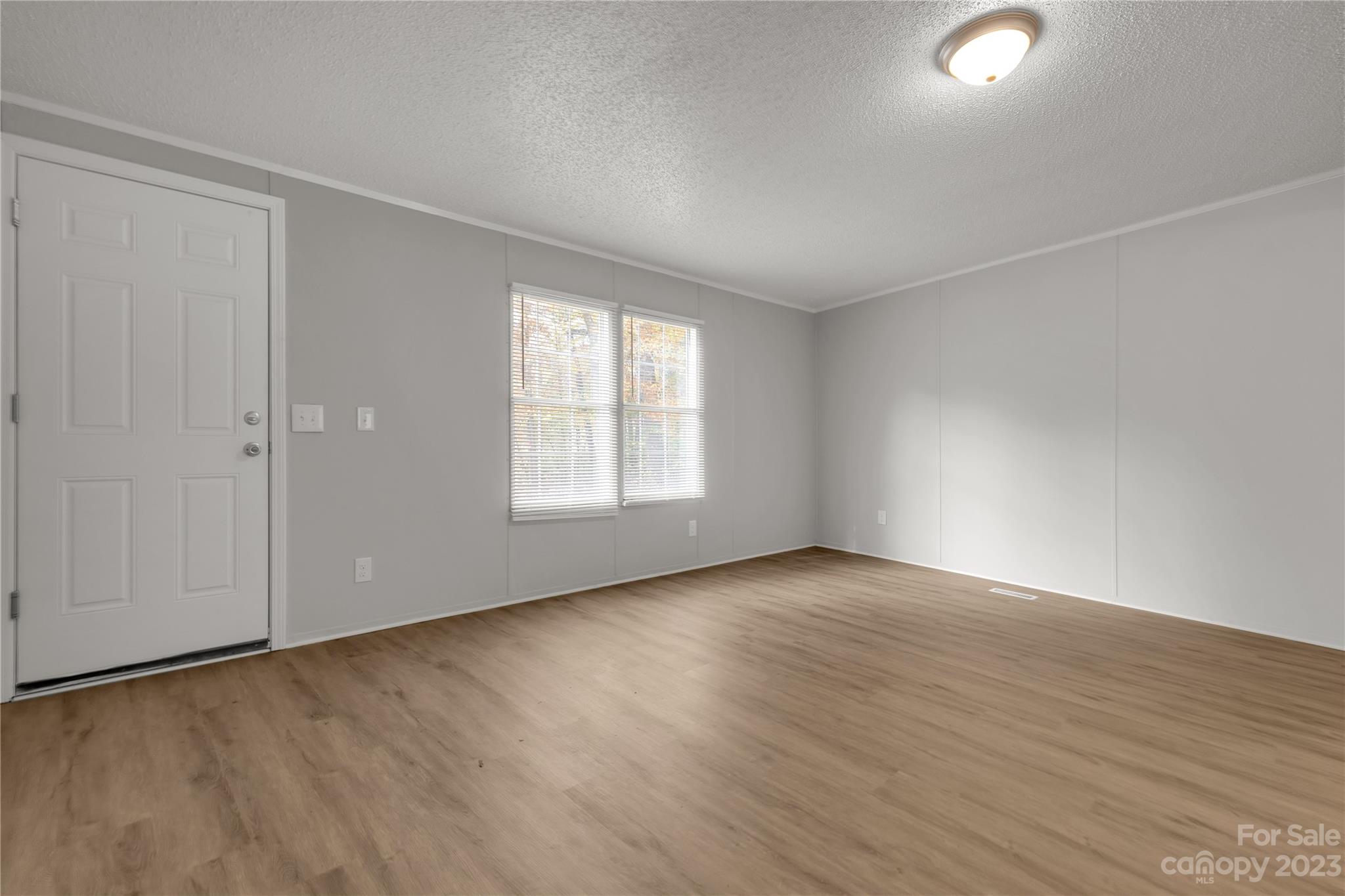 995 Longleaf Road York, SC 29745 - Photo 10 of 30 an empty room with wooden floor and windows