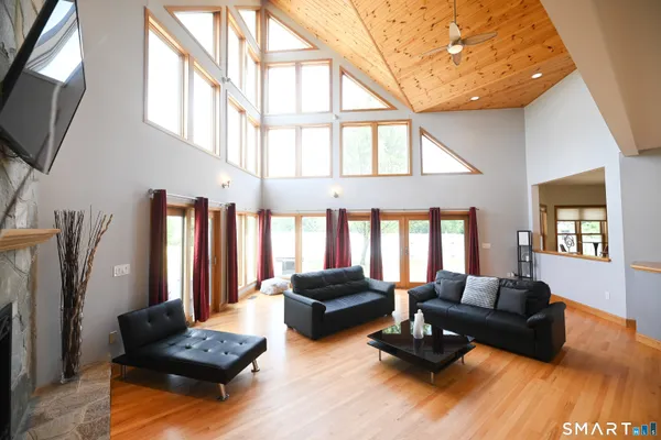 a living room with furniture fireplace and a large window