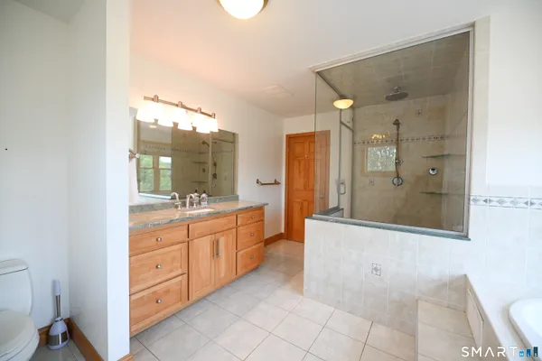 a bathroom with a granite countertop sink mirror and a