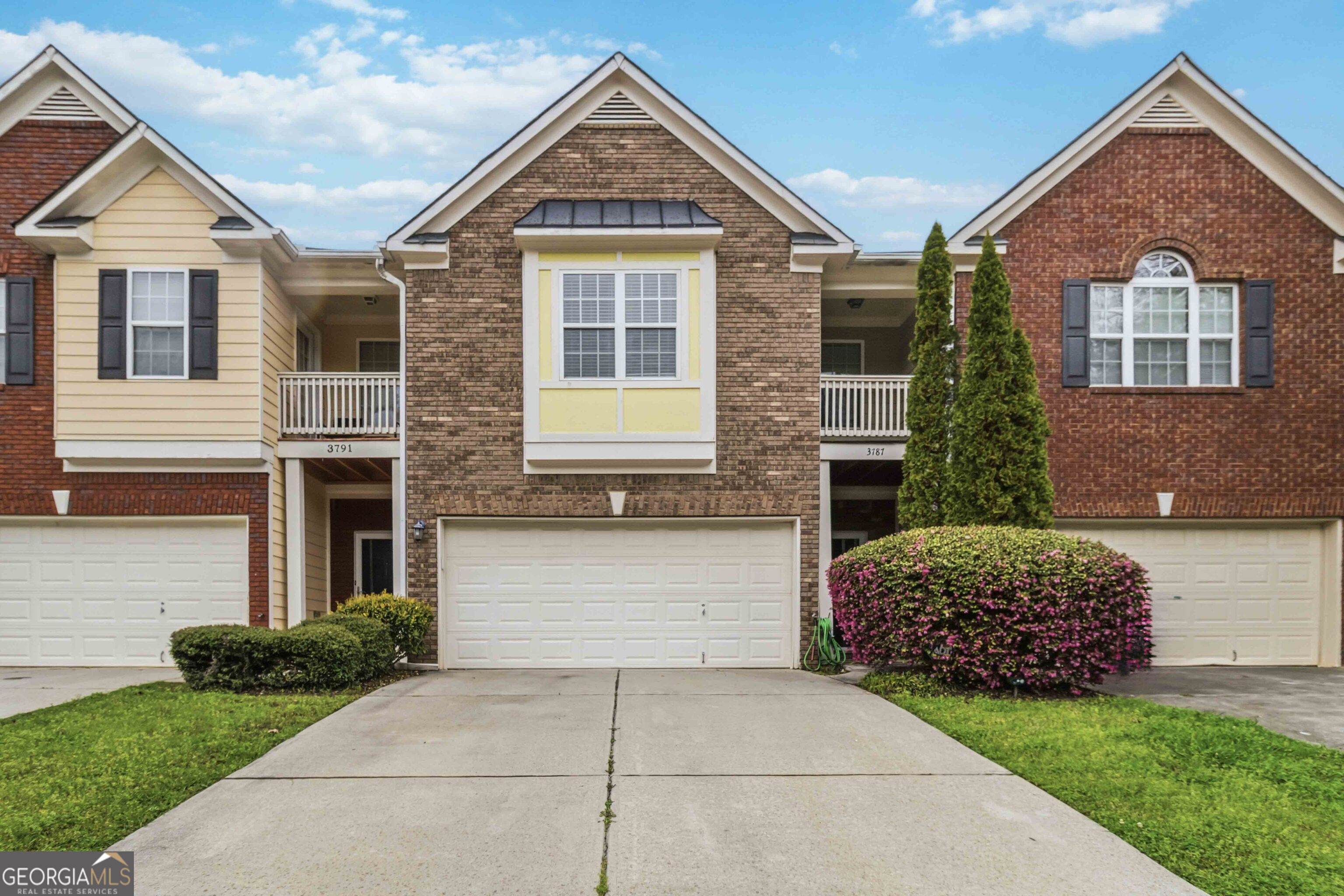 a front view of a house with a garden