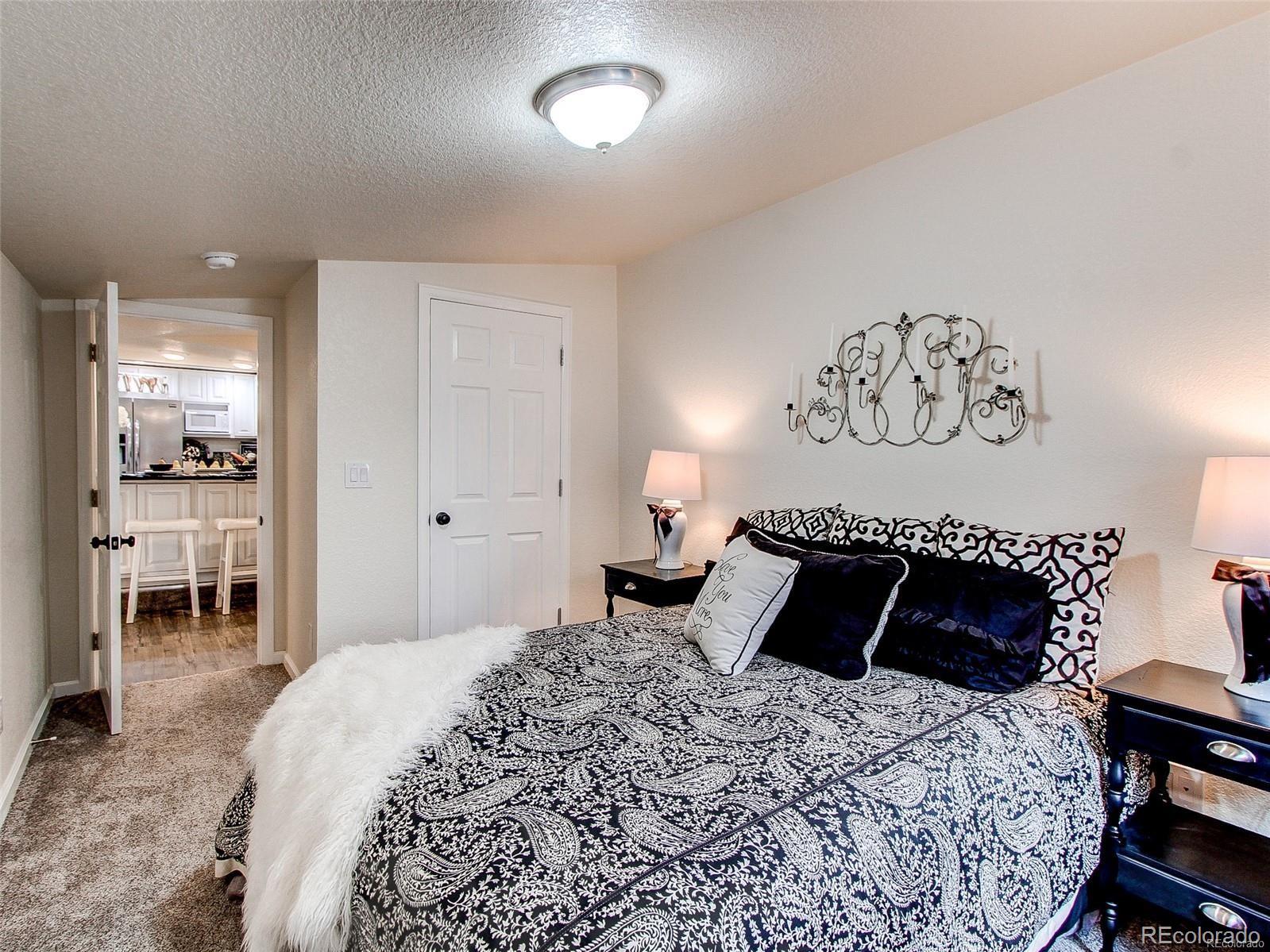 665 Juniper Street Golden, CO 80401 - Photo 14 of 44 a bedroom with a bed and a chair