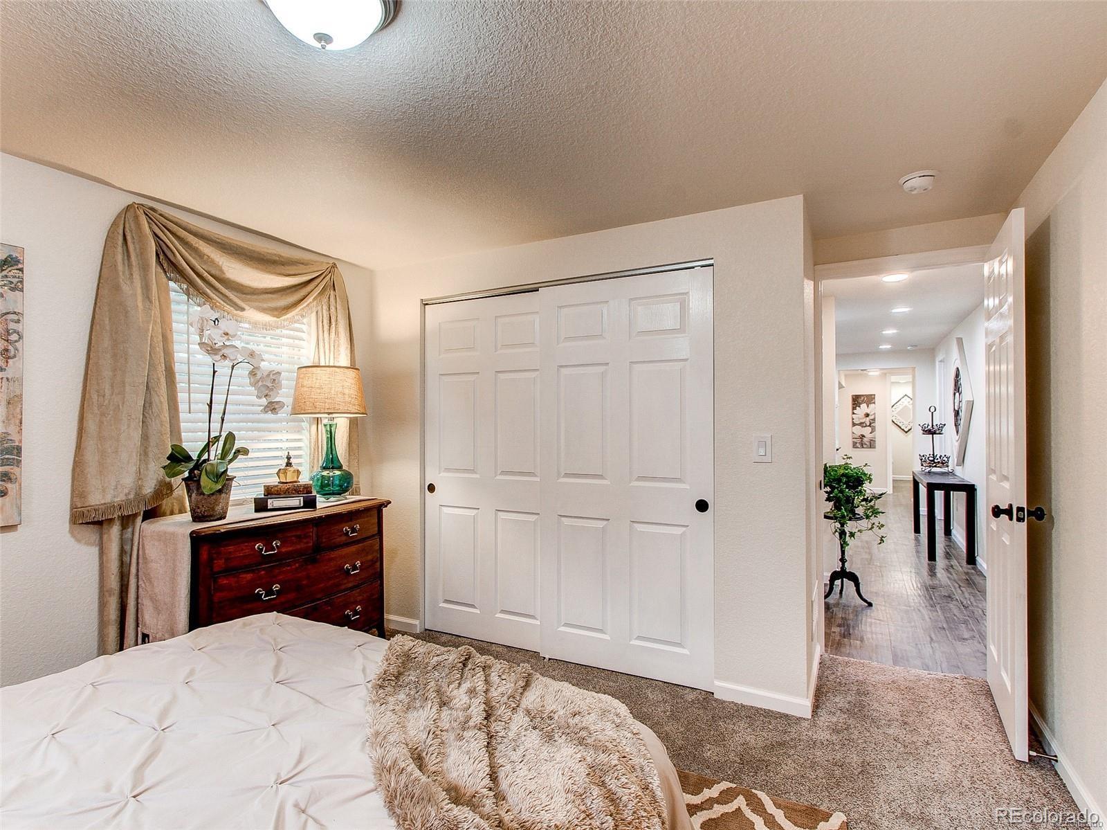 665 Juniper Street Golden, CO 80401 - Photo 19 of 44 a bedroom with a bed and a dresser