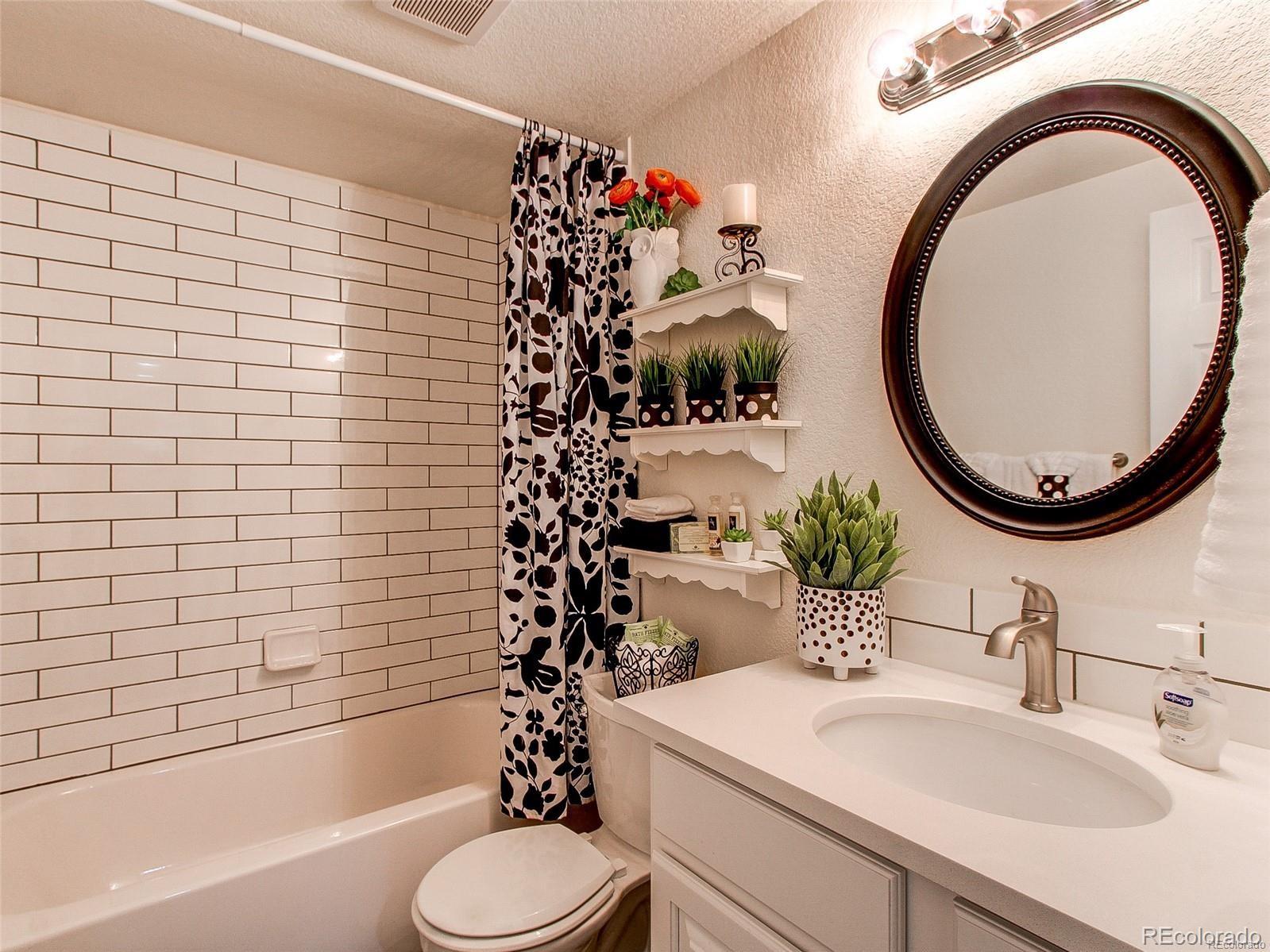 665 Juniper Street Golden, CO 80401 - Photo 20 of 44 a bathroom with a sink a mirror and a toilet