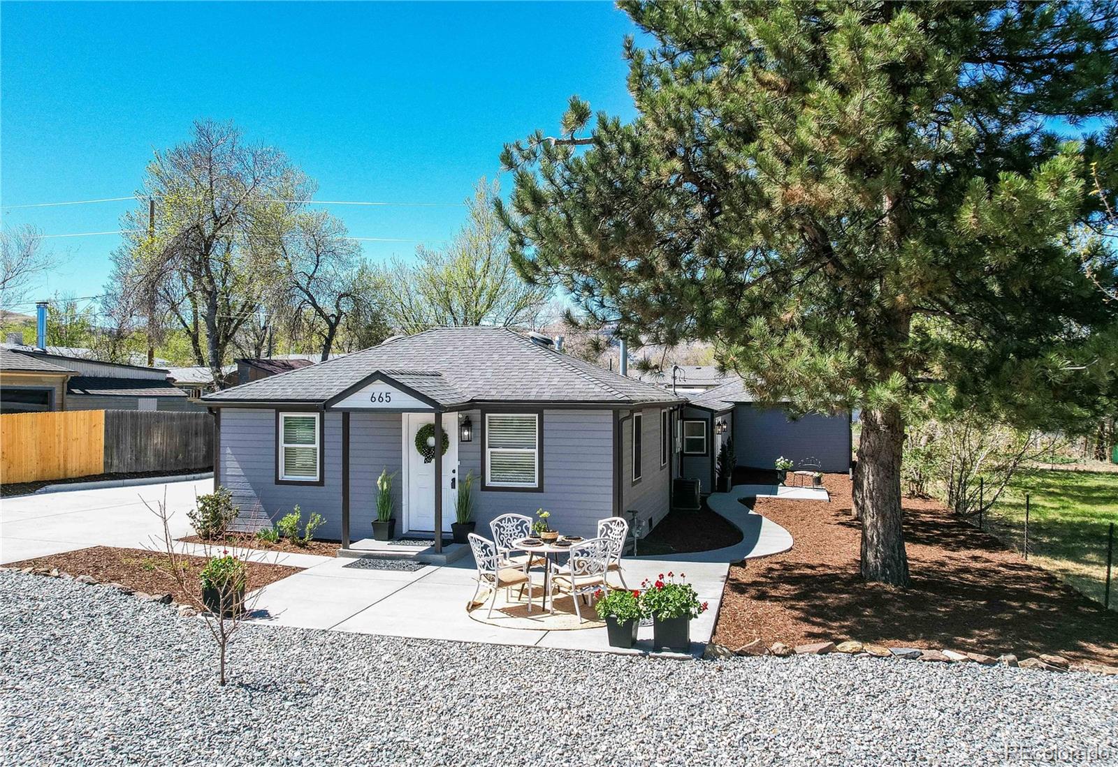665 Juniper Street Golden, CO 80401 - Photo 2 of 44 a front view of a house with garden and patio