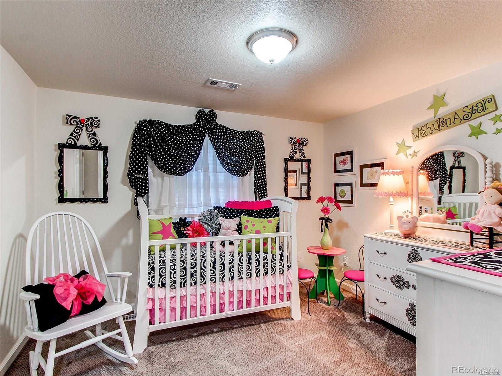 665 Juniper Street Golden, CO 80401 - Photo 21 of 44 a bedroom with furniture a baby bed and a baby crib