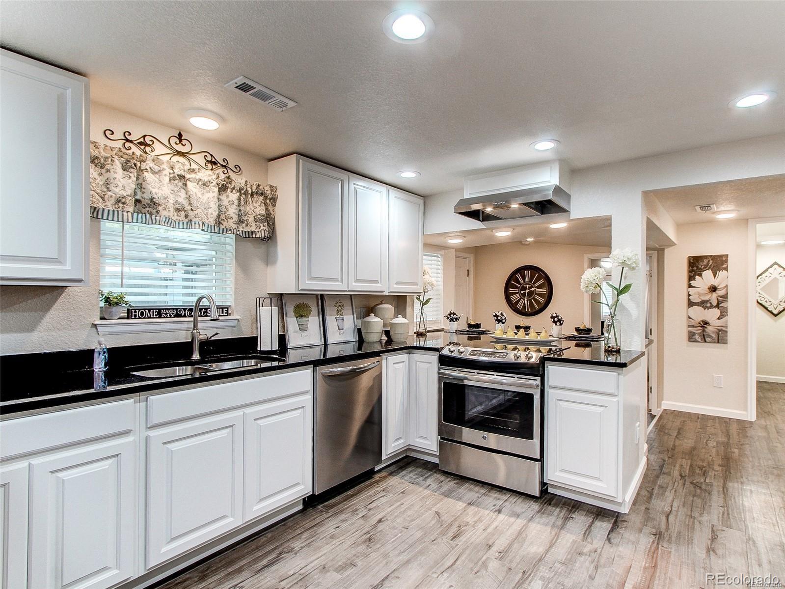665 Juniper Street Golden, CO 80401 - Photo 9 of 44 a kitchen with a stove and white cabinets