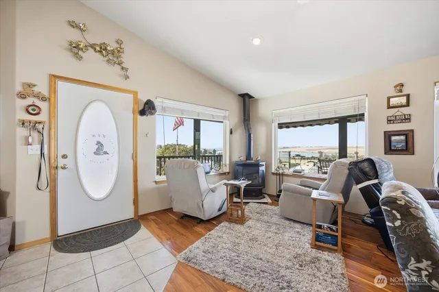 a living room with furniture a large window and a chandelier