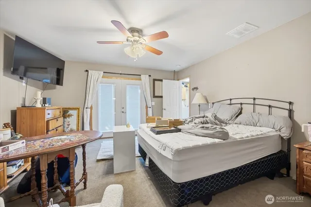 a bedroom with a bed and a chandelier