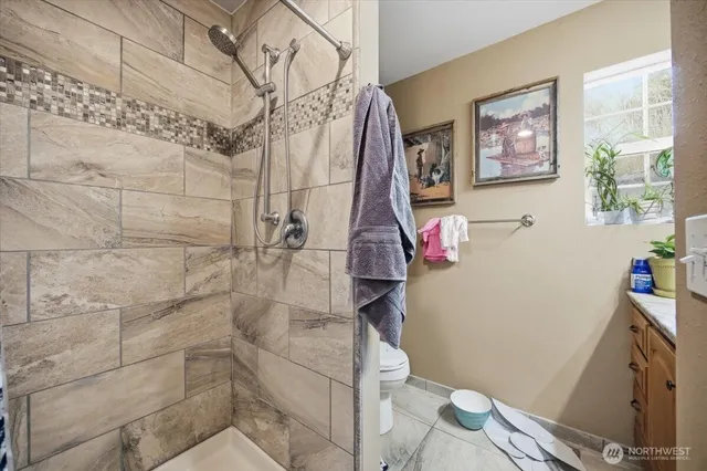 a bathroom with a toilet and a shower