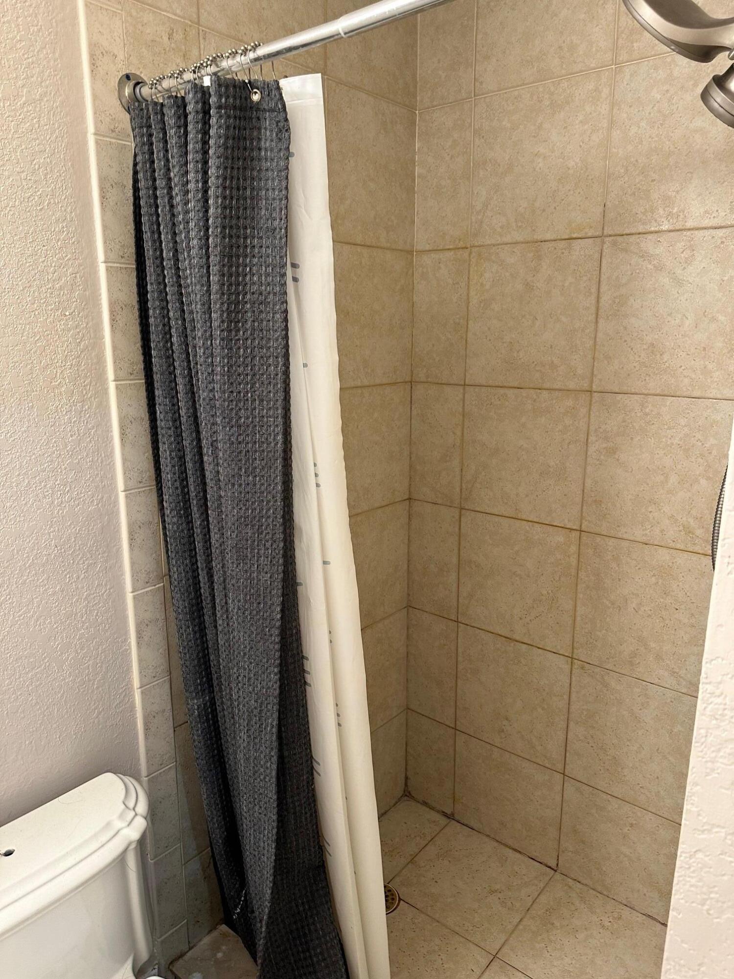272 Southwest 1st Street, Unit B Boca Raton, FL 33432 - Photo 11 of 17 a bathroom with a shower and a toilet
