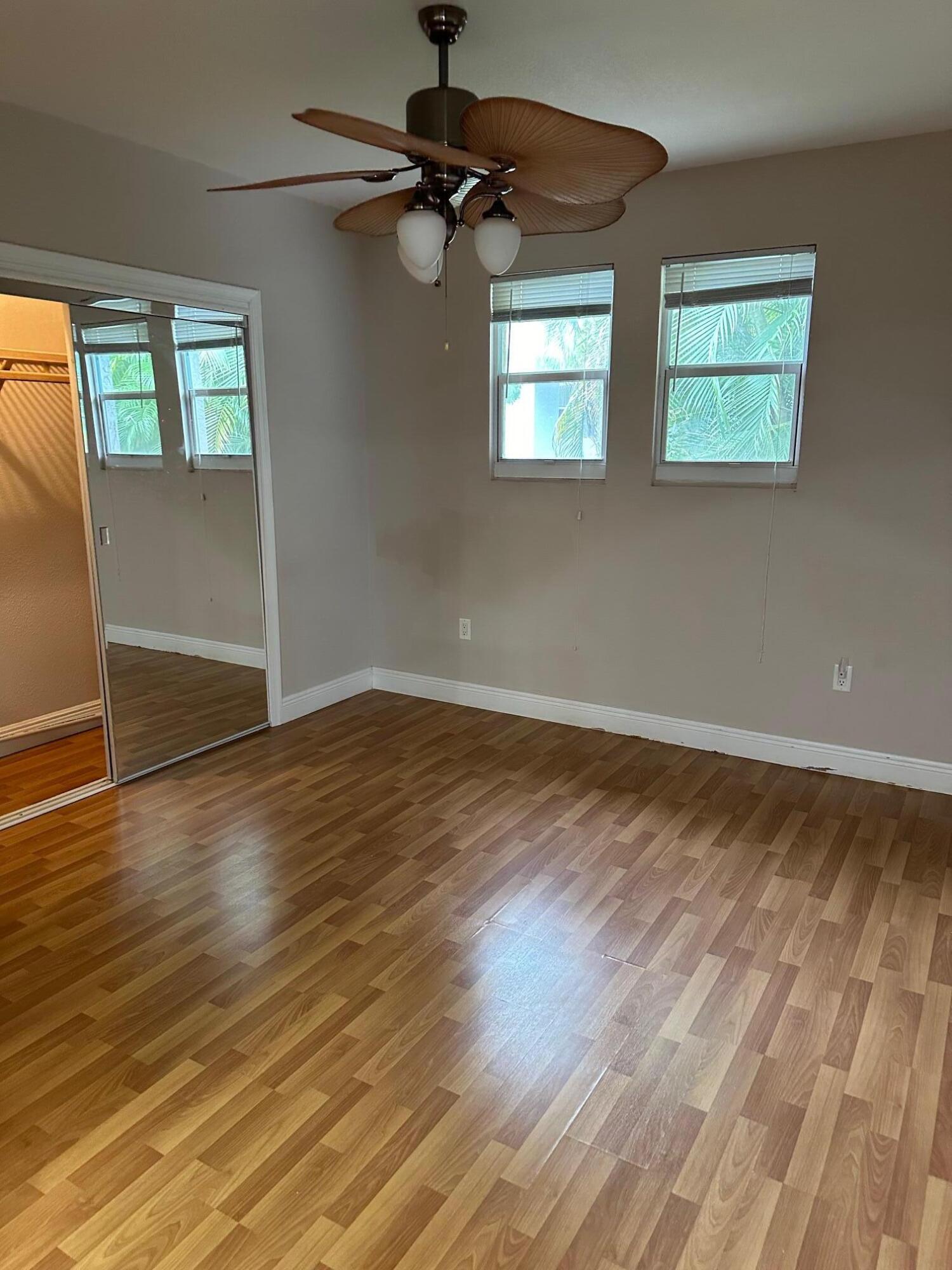 272 Southwest 1st Street, Unit B Boca Raton, FL 33432 - Photo 13 of 17 a view of an empty room with wooden floor and a window