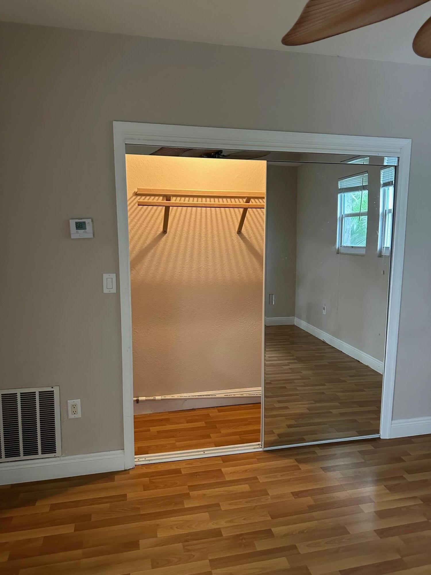 272 Southwest 1st Street, Unit B Boca Raton, FL 33432 - Photo 14 of 17 a view of empty room with wooden floor and fan