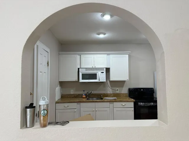 a kitchen with stainless steel appliances granite countertop a stove and a refrigerator